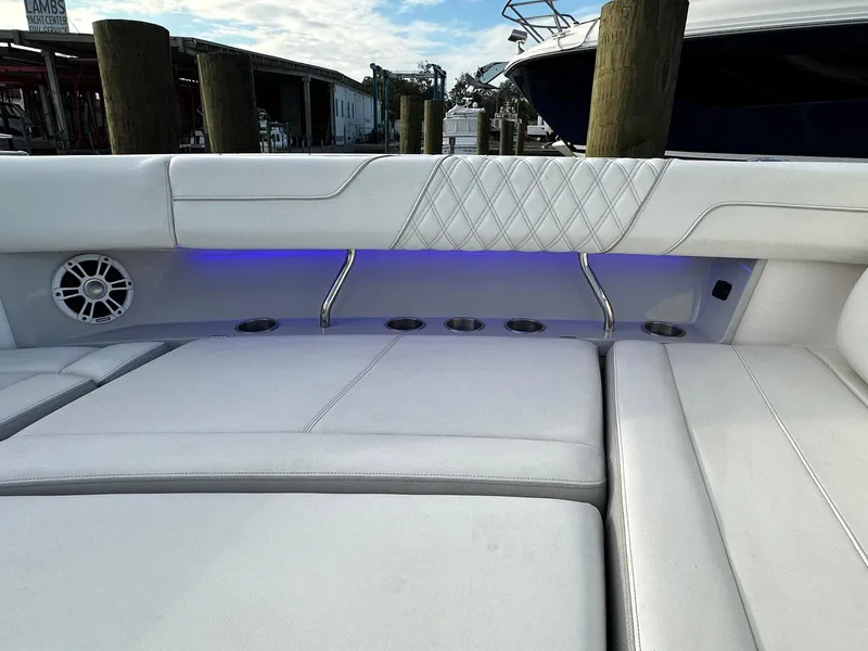 Slide: The Image of Luxurious seating on 2021 Regal 38 SAV boat with blue LED lighting. - 17