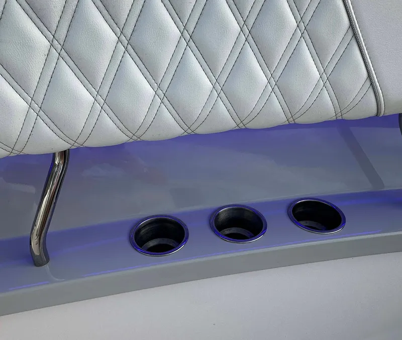 Slide: The Image of 2021 Regal 38 SAV boat interior with quilted seating and cup holders. - 19