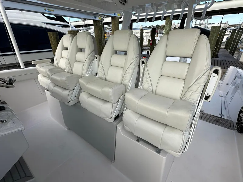 Slide: The Image of Luxurious seating on 2021 Regal 38 SAV boat, featuring plush white leather chairs. - 21