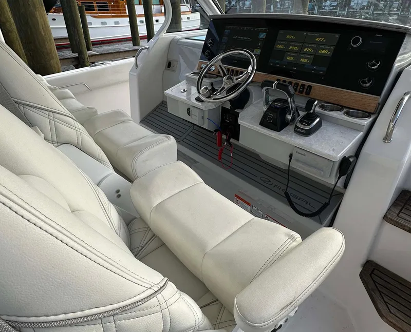 Slide: The Image of 2021 Regal 38 SAV boat cockpit with modern controls and plush seating. - 22