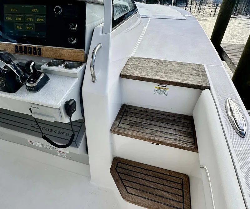 Slide: The Image of 2021 Regal 38 SAV boat interior with wooden steps and control panel. - 23