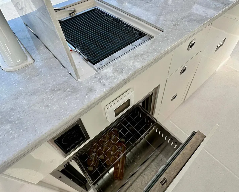 Slide: The Image of 2021 Regal 38 SAV yacht kitchen with grill and storage drawers. - 25