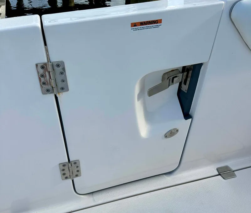 Slide: The Image of White door with latch on 2021 Regal 38 SAV boat deck. - 27