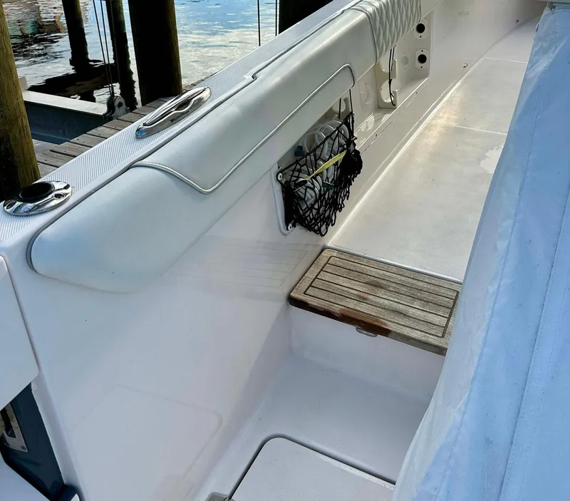 Slide: The Image of 2021 Regal 38 SAV boat interior with white seating and wooden step. - 28