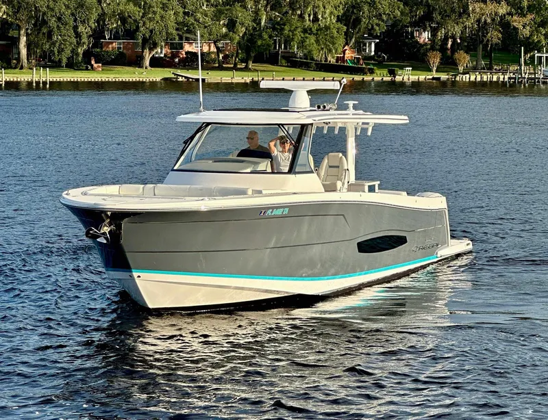 Slide: The Image of 2021 Regal 38 SAV boat cruising on a calm lake. - 3