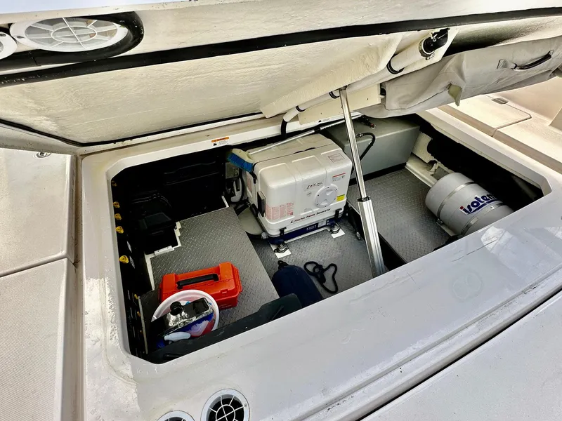Slide: The Image of 2021 Regal 38 SAV boat storage compartment with equipment and tools. - 31