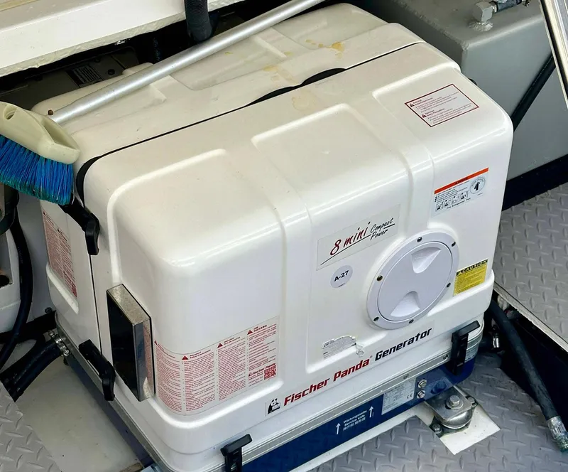 Slide: The Image of Fischer Panda generator on 2021 Regal 38 SAV boat, white casing, compact design. - 32
