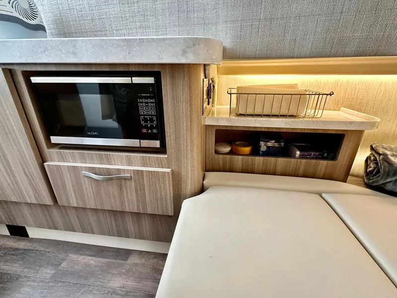 Slide: The Image of 2021 Regal 38 SAV interior with microwave, storage, and seating area. - 36