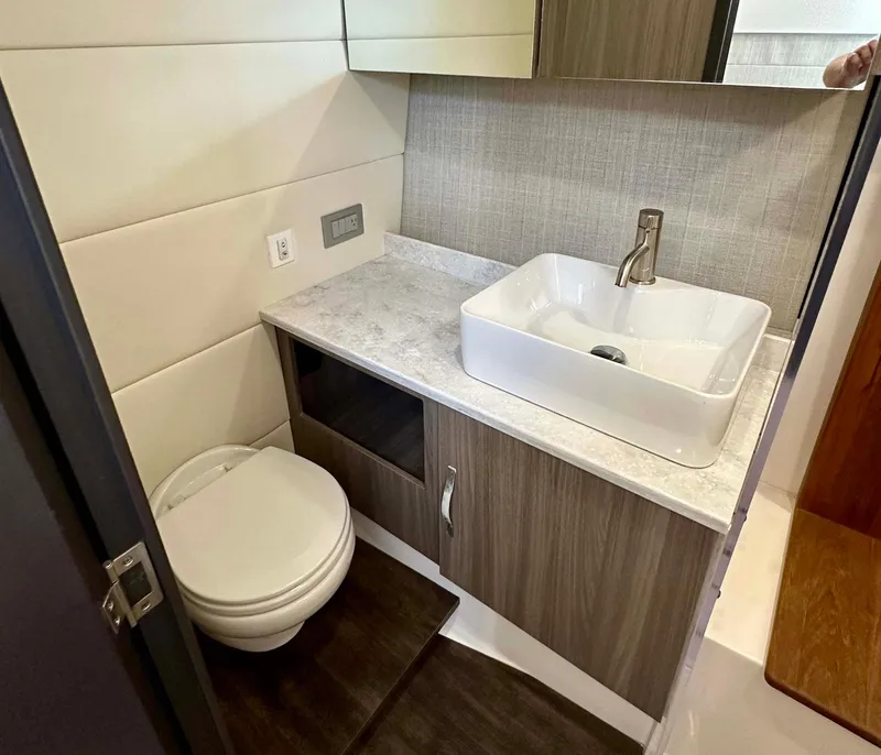 Slide: The Image of Modern bathroom in 2021 Regal 38 SAV yacht with sink and toilet. - 38