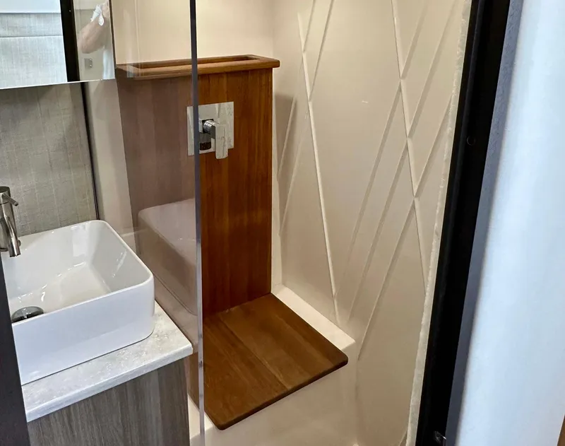 Slide: The Image of 2021 Regal 38 SAV bathroom with modern shower and sink design. - 39