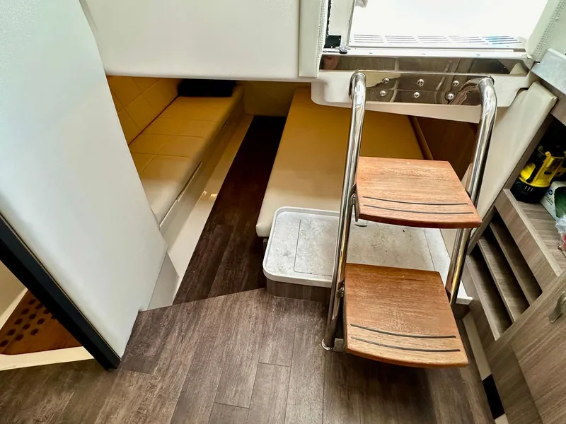 Slide: The Image of Interior of 2021 Regal 38 SAV boat with wooden steps and seating area. - 41