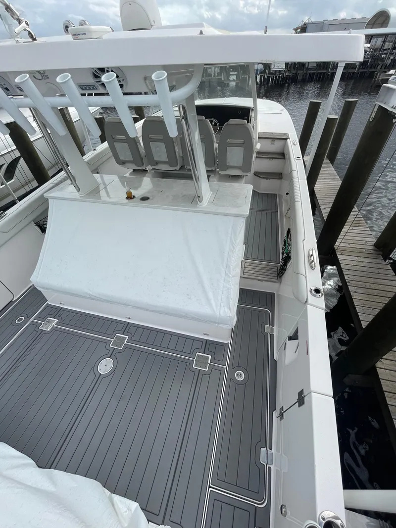 Slide: The Image of 2021 Regal 38 SAV boat docked, featuring spacious deck and modern design. - 43