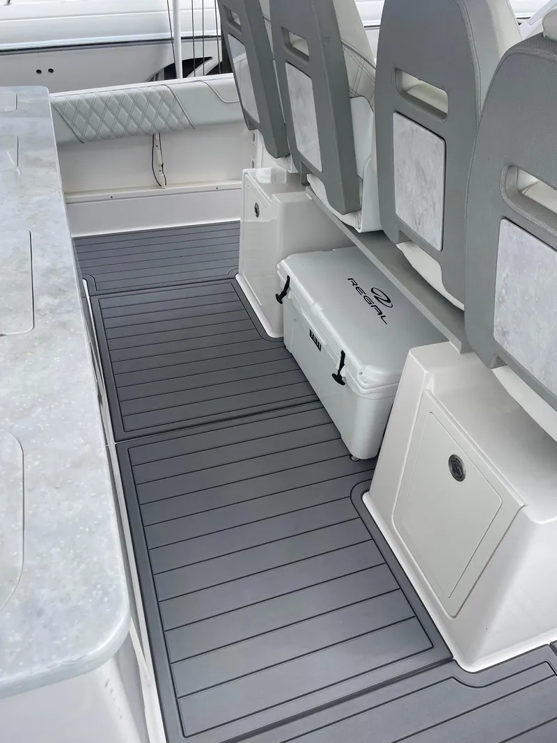 Slide: The Image of 2021 Regal 38 SAV boat interior with gray flooring and seating. - 45