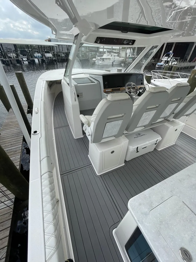 Slide: The Image of 2021 Regal 38 SAV boat interior with sleek seating and modern dashboard. - 47