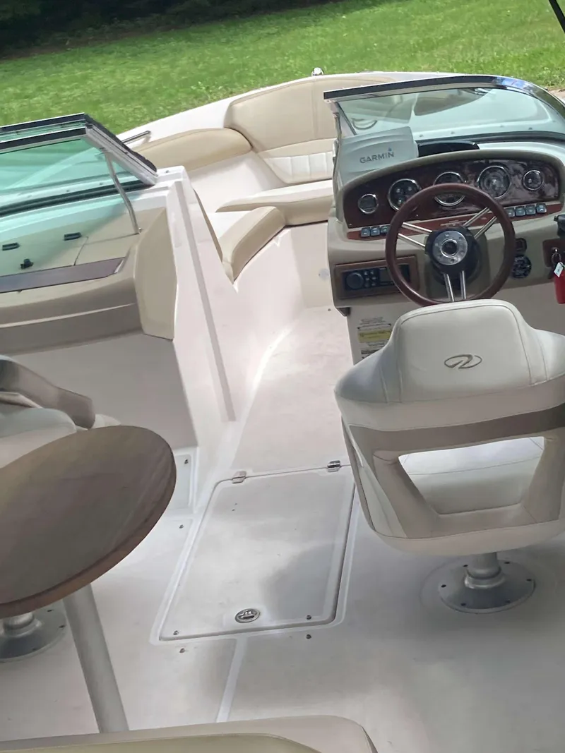 Slide: The Image of 2011 Regal 2200 boat interior with steering wheel and seating area. - 6