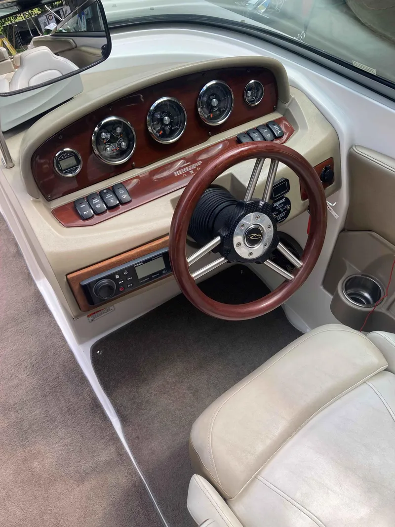 Slide: The Image of 2011 Regal 2200 boat dashboard with wood accents and steering wheel. - 7