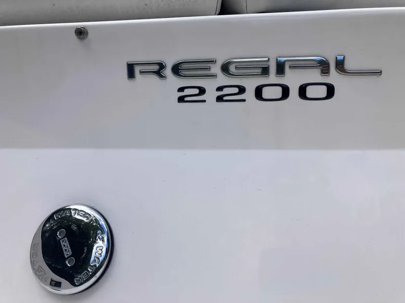 Slide: The Image of 2011 Regal 2200 boat logo on white surface. - 8