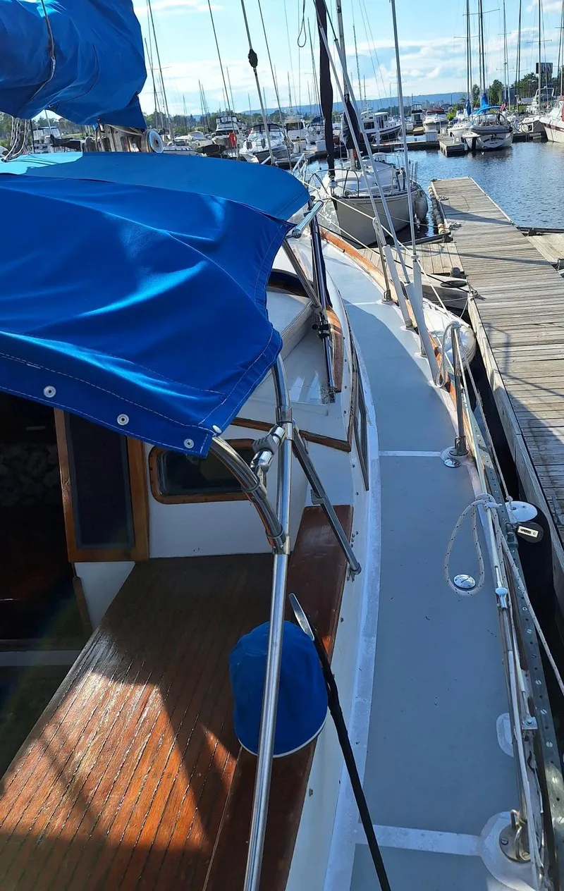 Slide: The Image of 1976 Cheoy Lee 40 Center Cockpit sailboat docked at marina with blue canopy. - 12