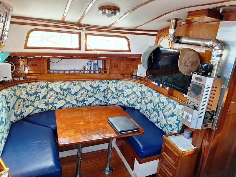 Slide: The Image of Interior of 1976 Cheoy Lee 40 Center Cockpit with floral upholstery and wooden table. - 18