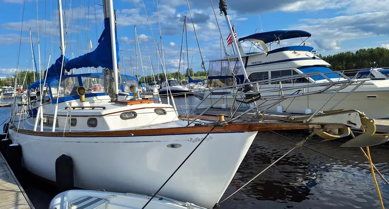 Slide: The Image of 1976 Cheoy Lee 40 Center Cockpit sailboat docked in a marina, surrounded by other boats. - 2