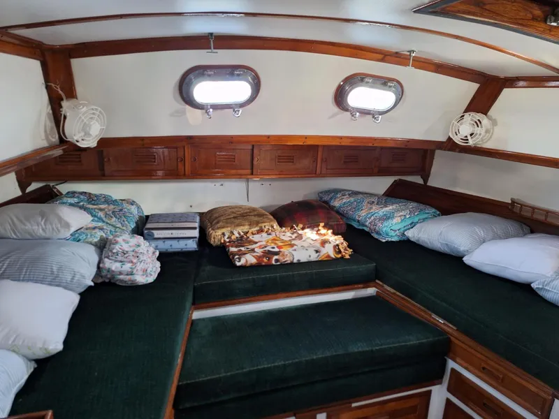 Slide: The Image of Interior of 1976 Cheoy Lee 40 Center Cockpit with cozy bedding and wooden accents. - 21