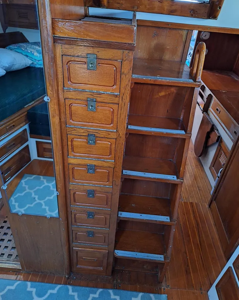 Slide: The Image of 1976 Cheoy Lee 40 Center Cockpit interior with wooden cabinetry and shelving. - 27