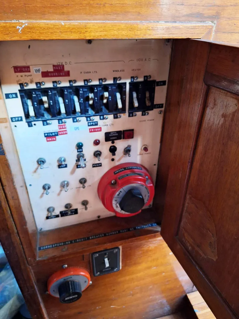 Slide: The Image of Electrical panel of a 1976 Cheoy Lee 40 Center Cockpit sailboat with switches and controls. - 37