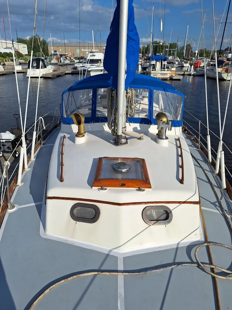 Slide: The Image of 1976 Cheoy Lee 40 Center Cockpit sailboat docked in a marina. - 6