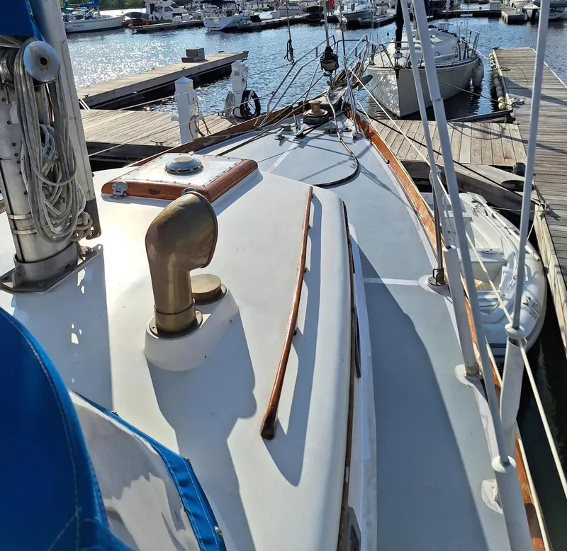 Slide: The Image of 1976 Cheoy Lee 40 Center Cockpit sailboat docked at marina, showcasing deck and rigging. - 7