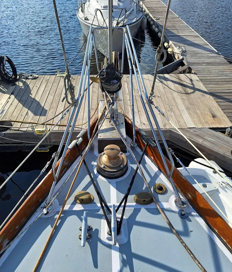 Slide: The Image of 1976 Cheoy Lee 40 Center Cockpit sailboat docked at a wooden pier. - 8