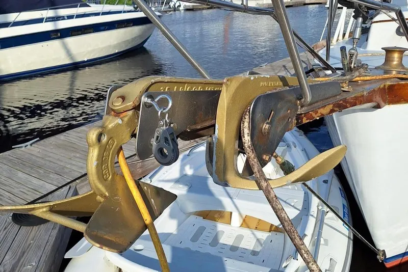 Slide: The Image of 1976 Cheoy Lee 40 Center Cockpit sailboat anchor detail at marina dock. - 9