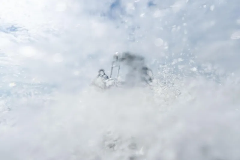 Slide: The Image of 2025 BlueZones Boatworks 16' Flats navigating through splashing water. - 13