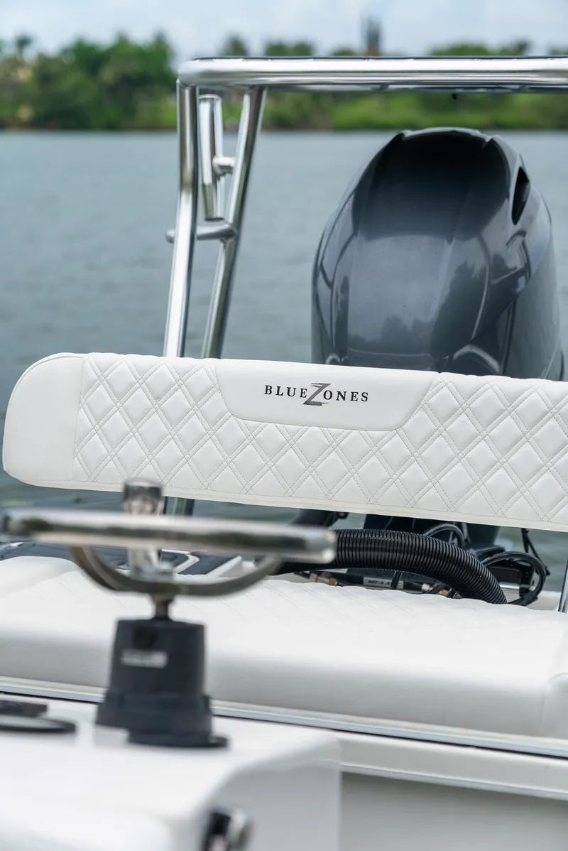 Slide: The Image of 2025 BlueZones Boatworks 16' Flats boat with sleek design and powerful engine on water. - 23