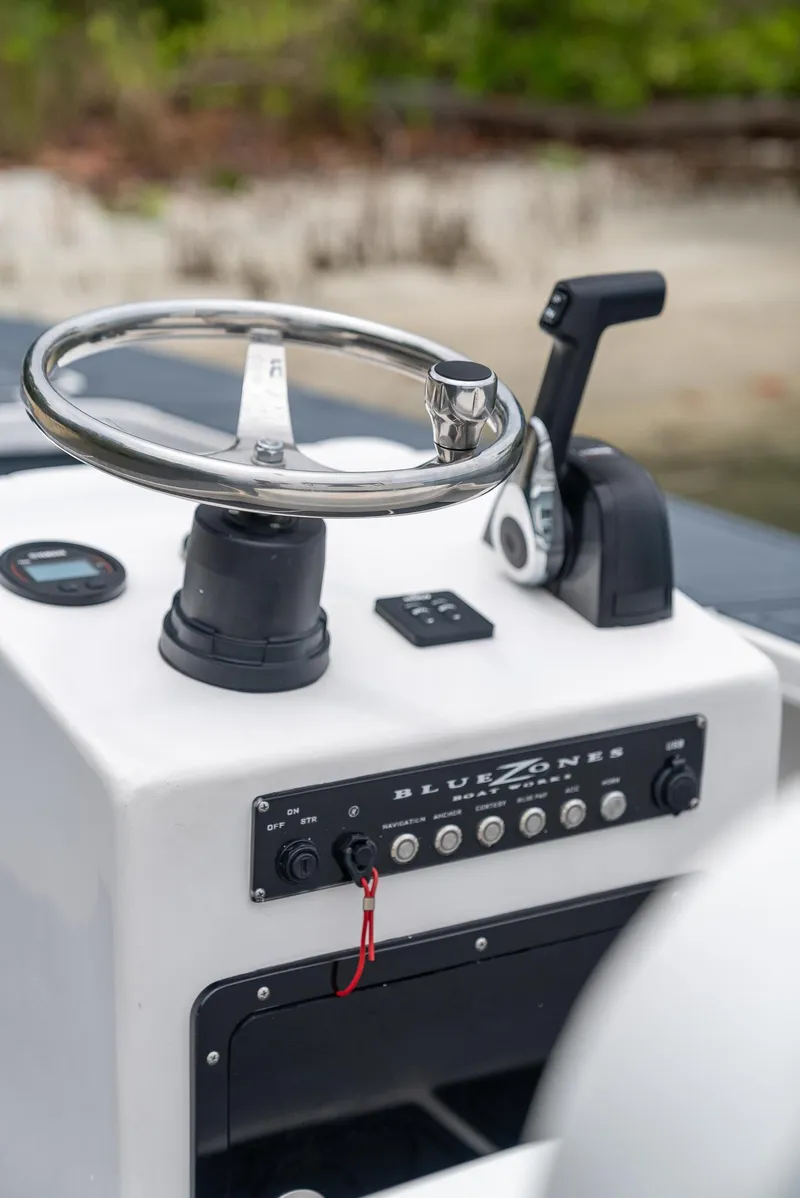 Slide: The Image of 2025 BlueZones Boatworks 16' Flats steering console with controls and steering wheel. - 26