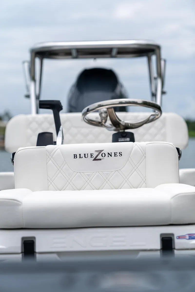Slide: The Image of 2025 BlueZones Boatworks 16' Flats boat interior with steering wheel and seating. - 29