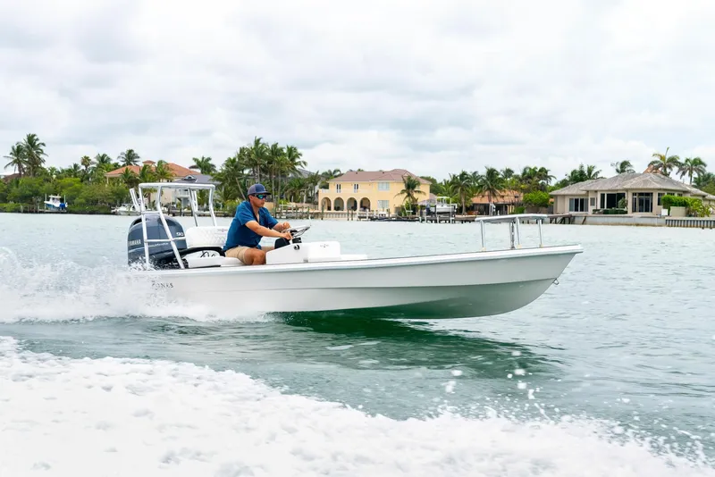 Slide: The Image of 2025 BlueZones Boatworks 16' Flats cruising on a scenic waterway. - 39