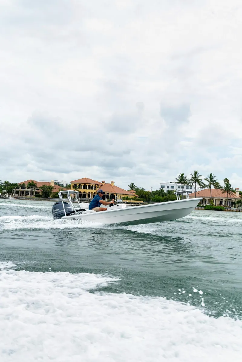 Slide: The Image of 2025 BlueZones Boatworks 16' Flats boat cruising on a scenic waterway. - 41