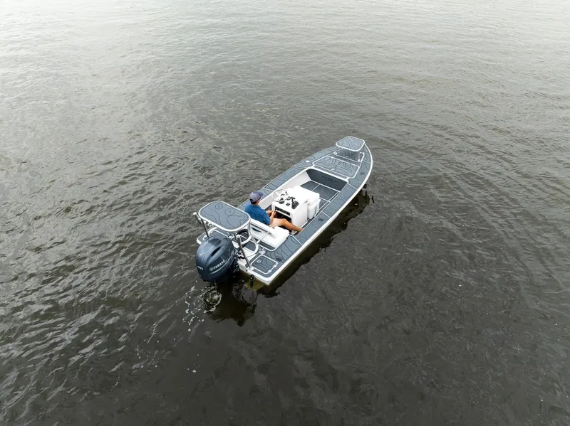 Slide: The Image of 2025 BlueZones Boatworks 16' Flats on calm water, aerial view. - 43