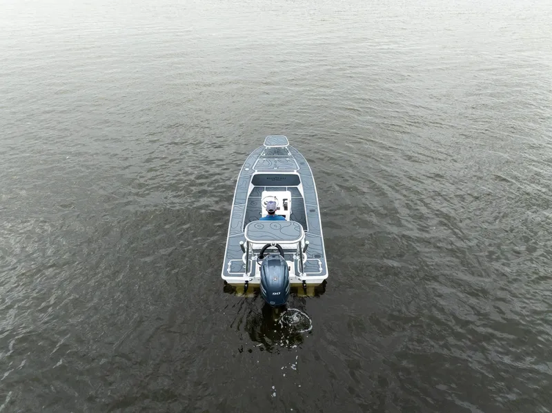 Slide: The Image of 2025 BlueZones Boatworks 16' Flats boat on calm water, aerial view. - 44