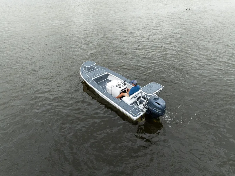 Slide: The Image of 2025 BlueZones Boatworks 16' Flats boat on calm water, aerial view. - 45