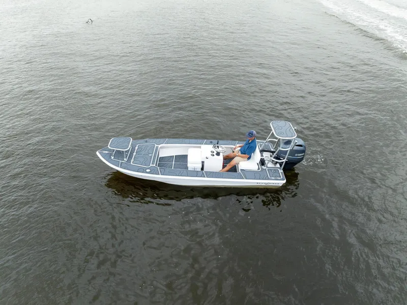 Slide: The Image of 2025 BlueZones Boatworks 16' Flats boat on calm water, aerial view. - 46
