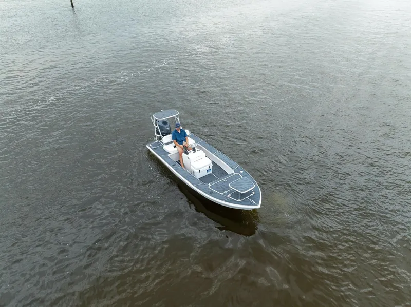 Slide: The Image of 2025 BlueZones Boatworks 16' Flats boat on calm water, aerial view. - 47