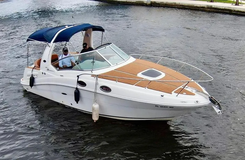 Slide: The Image of 2005 Sea Ray 260 Sundancer boat cruising on a calm waterway. - 0