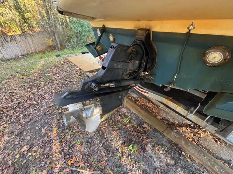Slide: The Image of 2005 Sea Ray 260 Sundancer boat stern with outboard motor in a wooded area. - 10