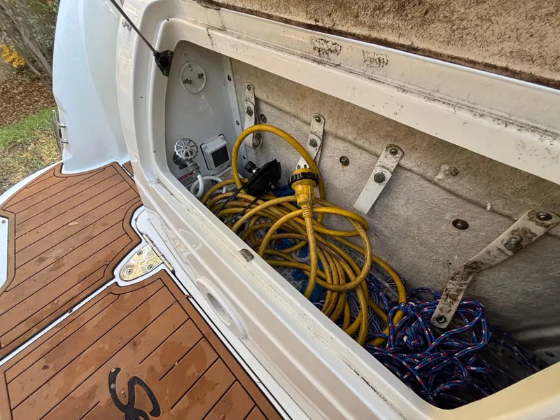 Slide: The Image of Storage compartment of 2005 Sea Ray 260 Sundancer with yellow power cords. - 11