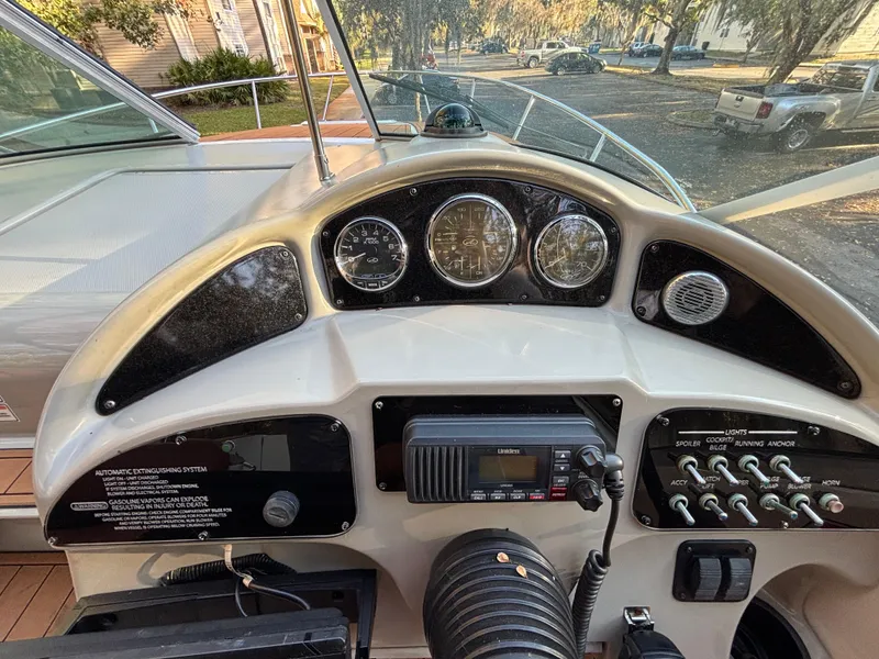 Slide: The Image of Dashboard of a 2005 Sea Ray 260 Sundancer boat with gauges and controls. - 16