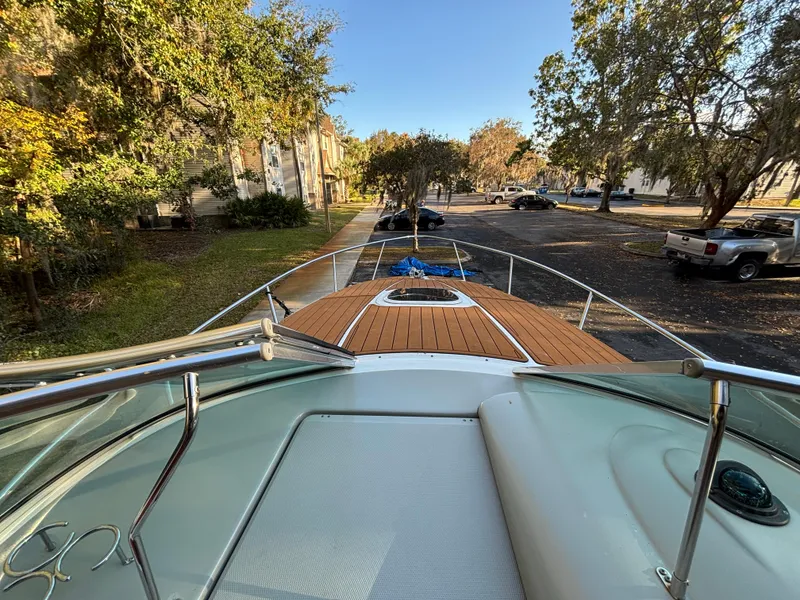 Slide: The Image of 2005 Sea Ray 260 Sundancer boat docked in a scenic residential area. - 18