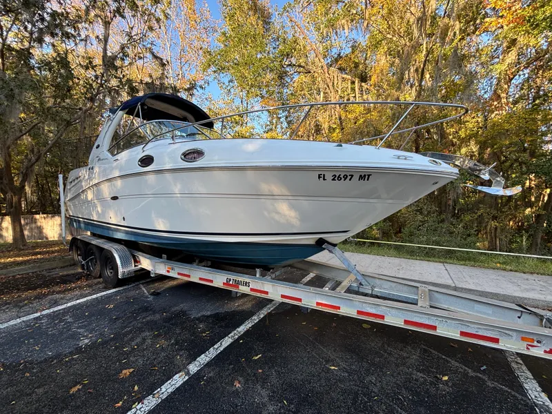 Slide: The Image of 2005 Sea Ray 260 Sundancer on trailer, parked in wooded area. - 2
