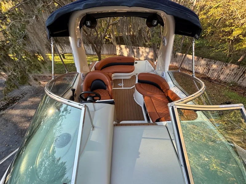 Slide: The Image of 2005 Sea Ray 260 Sundancer boat interior with brown seating and open deck view. - 20