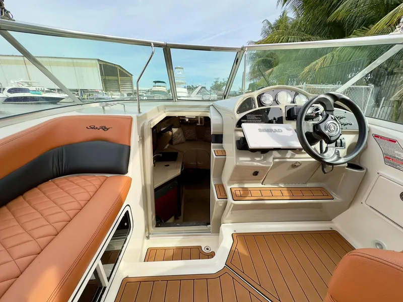 Slide: The Image of 2005 Sea Ray 260 Sundancer boat interior with helm, seating, and cabin view. - 22
